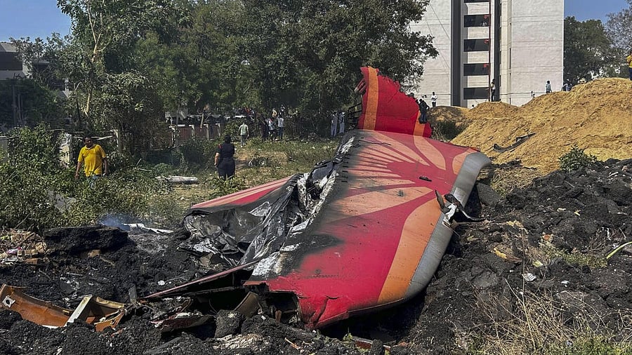 <div class="paragraphs"><p> People near the debris of the Air India plane that crashed moments after taking off from the airport, in Ahmedabad, Thursday, June 12, 2025. </p></div>