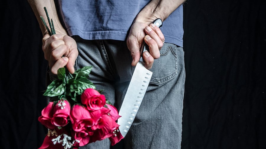 <div class="paragraphs"><p>Image showing a man holding flowers and a knife.</p></div>