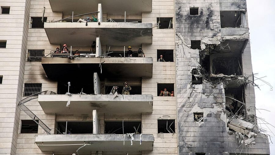 <div class="paragraphs"><p>Rescue and security personnel work inside an impacted residential building following missile attack from Iran on Israel, central Israel.</p></div>