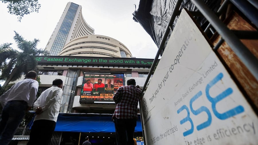 <div class="paragraphs"><p>People stand outside the Bombay Stock Exchange (BSE)</p></div>