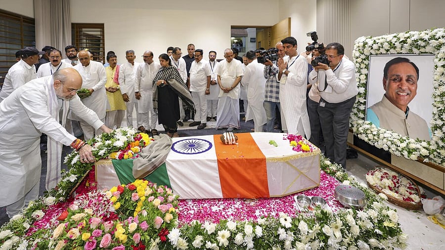 <div class="paragraphs"><p>Union Home Minister Amit Shah pays tribute to former Gujarat Chief Minister and senior BJP leader Vijay Rupani, who died in Ahmedabad plane crash, in Rajkot, Monday, June 16, 2025. </p></div>