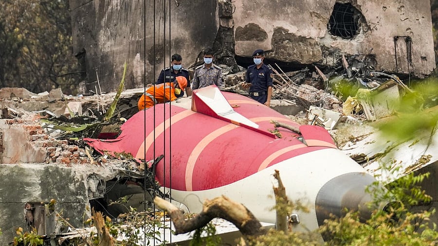 <div class="paragraphs"><p>Wreckage of the crashed Air India plane being lifted through a crane, in Ahmedabad</p></div>