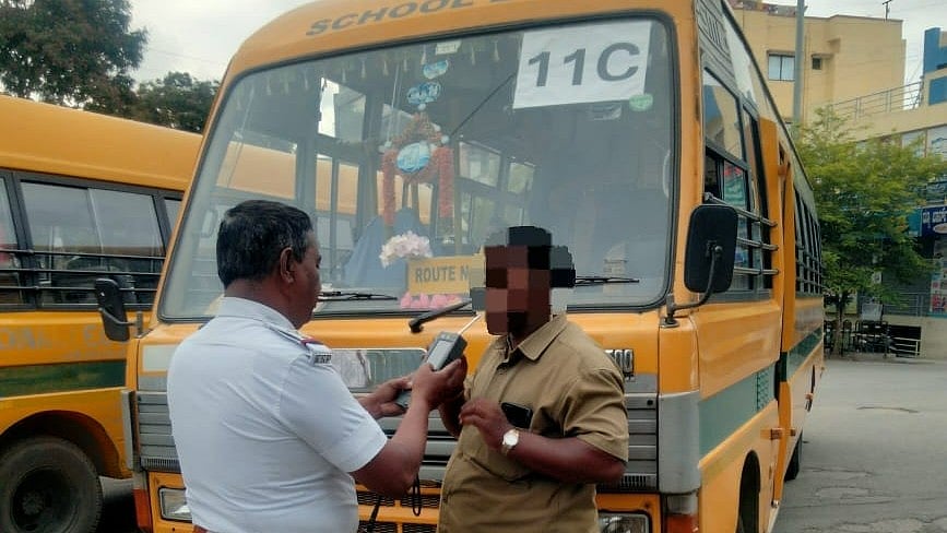 <div class="paragraphs"><p>A policeman makes a driver blow into a breathalyzer on Monday, in a special crackdown against drunk driving. </p></div>
