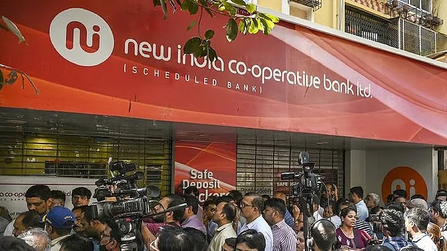 <div class="paragraphs"><p>People line up outside New India Cooperative Bank</p></div>