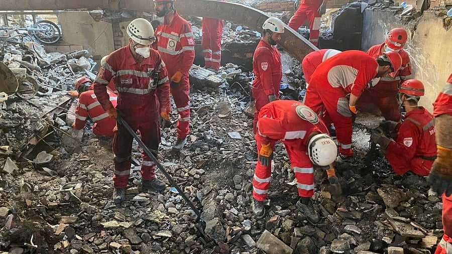 <div class="paragraphs"><p>Iranian Red Crescent Society members search through the rubble for victims after Israeli strikes, at an unspecified location in Iran, in this undated image released June 17, 2025.&nbsp;</p></div>