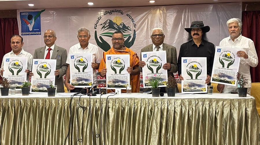 A N Yellappa Reddy, former secretary to the environment and ecology department, C D Kiran, president of Universal Human Rights Service Foundation, Santosh Bharati Swami, film director Rajendra Singh Babu and others release a poster of ‘Save Nandi Hills’ campaign in Bengaluru.