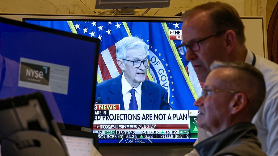 <div class="paragraphs"><p>Traders work, as a screen broadcasts a news conference by US Federal Reserve Chair Jerome Powell following the Fed rate announcement, on the floor of the New York Stock Exchange in New York City, June 18, 2025. </p></div>