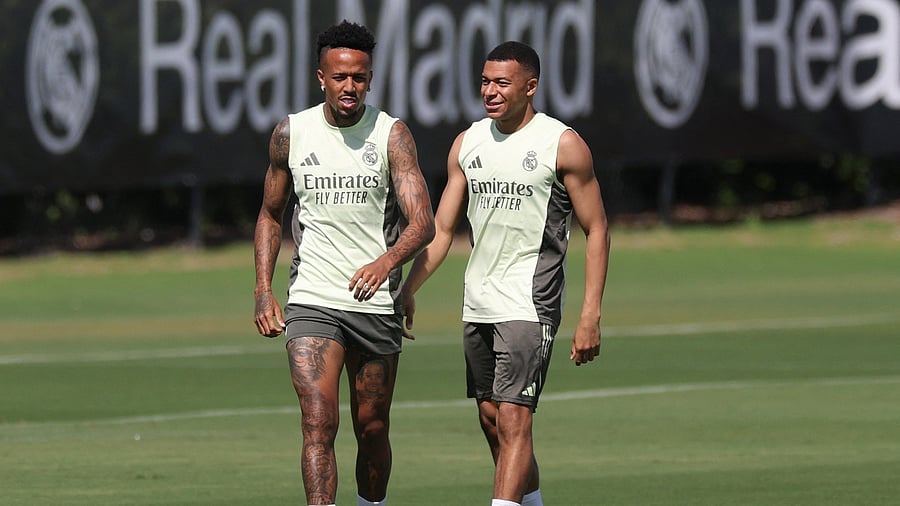 <div class="paragraphs"><p> Real Madrid's Eder Militao and Kylian Mbappe during training.</p></div>