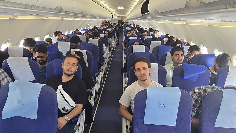 <div class="paragraphs"><p>Image showing students on board the flight back to Delhi.</p></div>