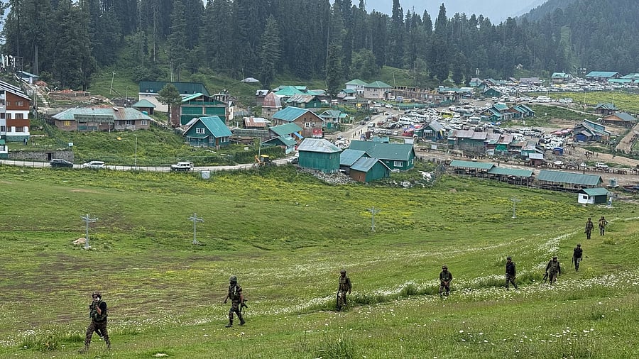 <div class="paragraphs"><p>Indian Army soldiers move through a meadow in Gulmarg, a ski resort and one of the main tourist attractions in the Kashmir region.</p></div>