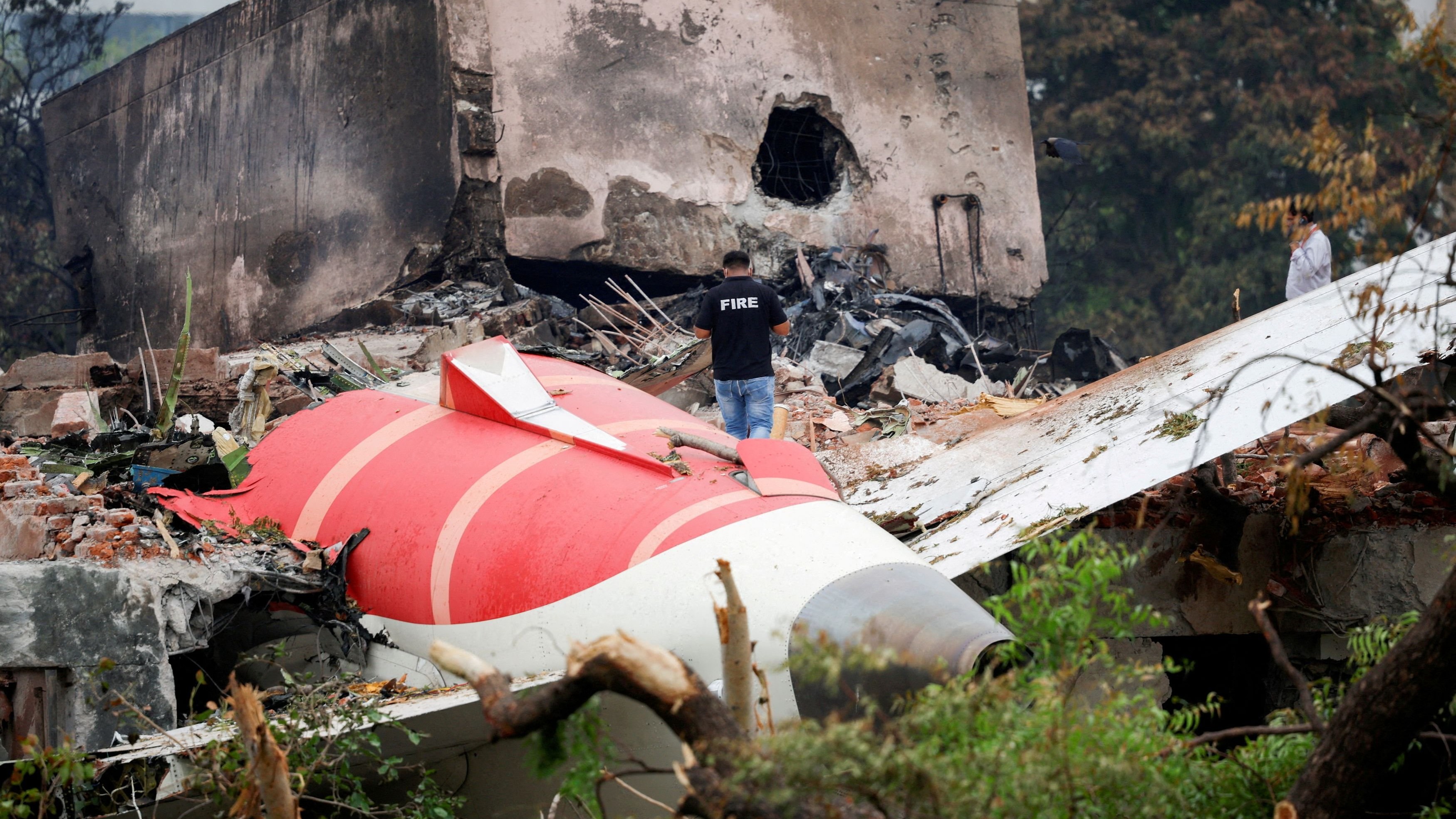 <div class="paragraphs"><p>A fire officer stands next to the crashed Air India Boeing 787-8 Dreamliner aircraft, in Ahmedabad</p></div>
