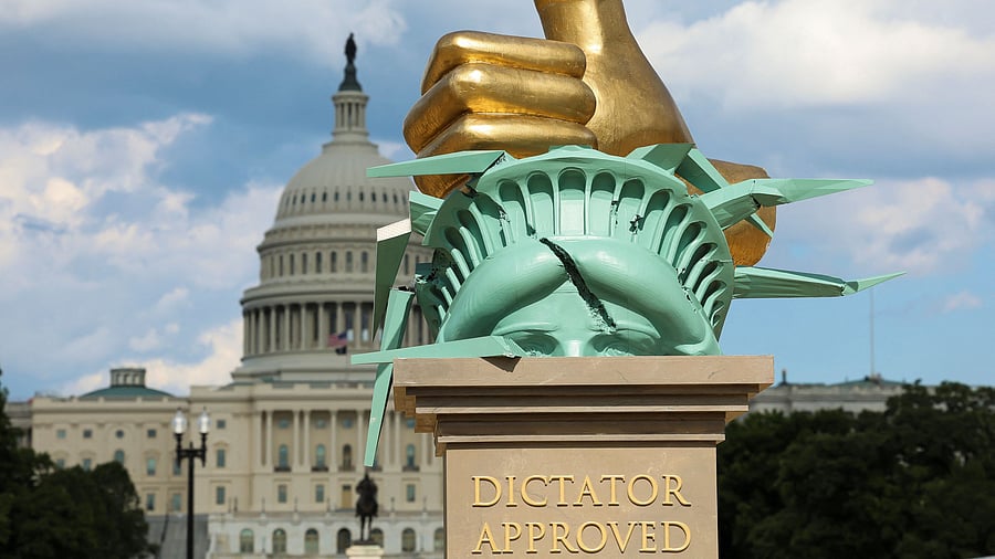 <div class="paragraphs"><p>An eight-foot-tall 'Dictator Approved' sculpture with a gold-painted hand smashing the crown of the Statue of Liberty is seen at the National Mall in Washington, D.C., U.S., June 20, 2025.</p></div>