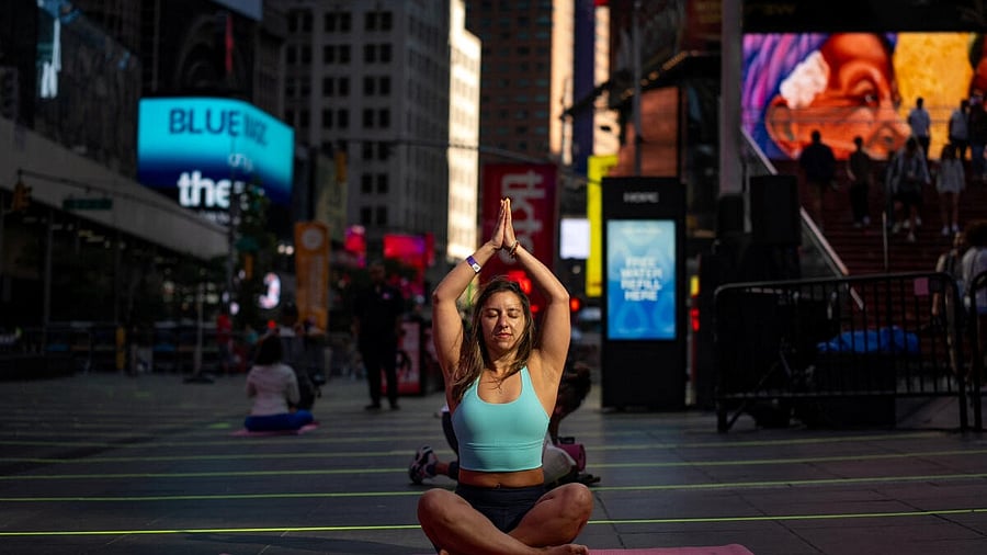 <div class="paragraphs"><p>A woman practises yoga during the 23rd annual "Solstice in Times Square: Mind Over Madness Yoga" event at Times Square, New York.</p></div>