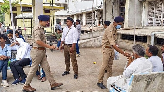 <div class="paragraphs"><p>Police personnel assist families of Air India plane crash victims as they wait for DNA identification at the Civil Hospital in Ahmedabad.</p></div>