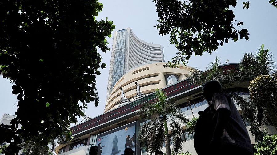 <div class="paragraphs"><p>Men walk past a screen displaying market results outside the Bombay Stock Exchange  in Mumbai</p></div>