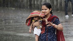 <div class="paragraphs"><p>A woman carries her child through a heavy rain shower in the northern Indian city of Chandigarh</p></div>
