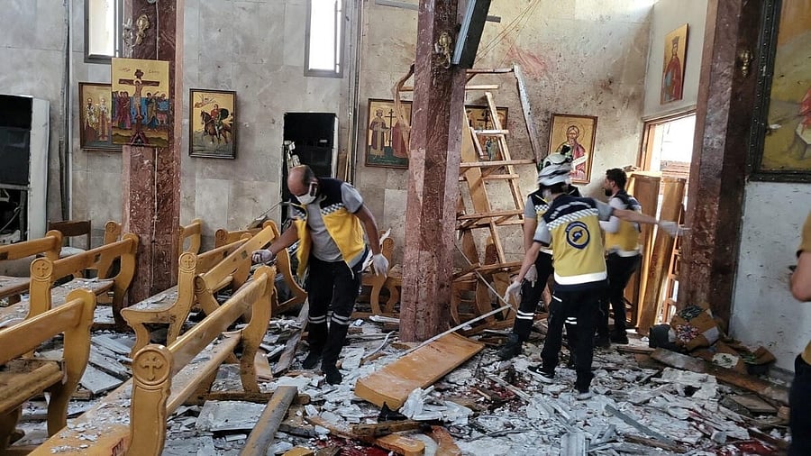 <div class="paragraphs"><p>Civil defence members inspect the damage after a blast rocked the Mar Elias Church according to witnesses, in the Dweila neighbourhood of Damascus</p></div>