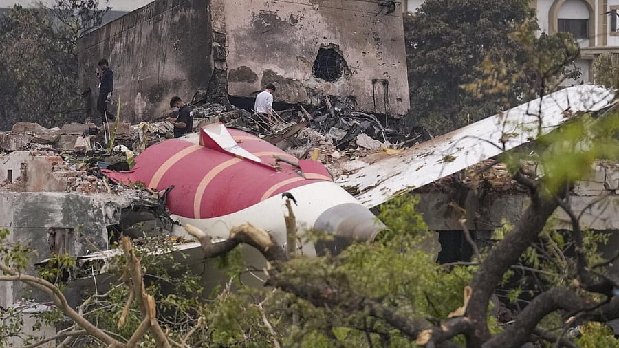 <div class="paragraphs"><p> Remains of the crashed Air India plane lie on a building, in Ahmedabad.</p></div>