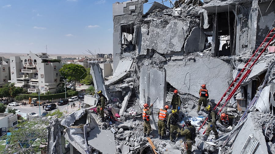<div class="paragraphs"><p>A drone view shows emergency personnel working at an impacted residential site, following a missile attack from Iran on Israel.</p></div>