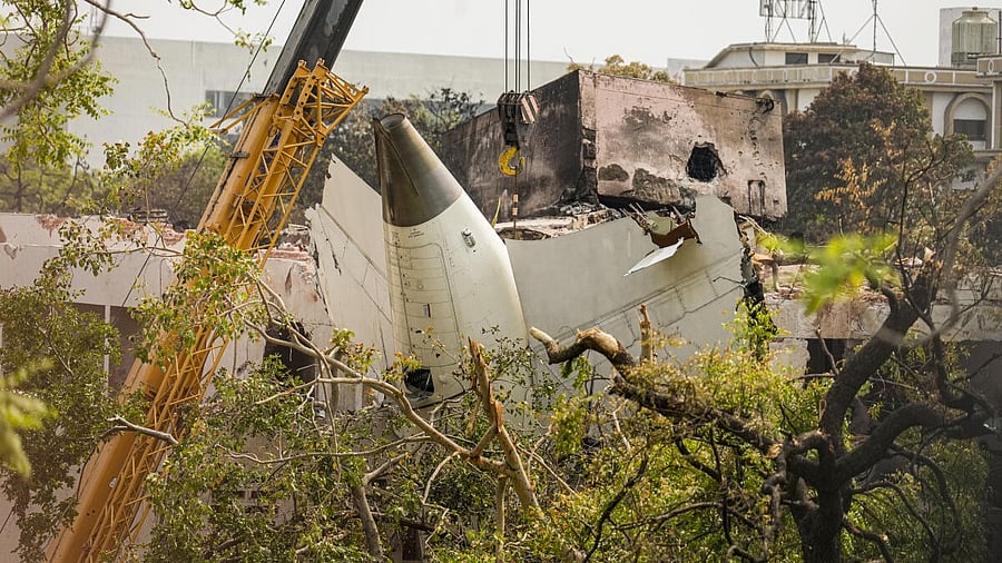 <div class="paragraphs"><p>Wreckage of the crashed Air India plane being lifted through a crane, in Ahmedabad, Gujarat, Saturday, June 14, 2025.</p></div>