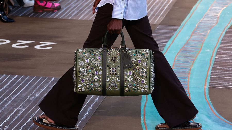 <div class="paragraphs"><p>A model presents a creation by designer and musician Pharrell Williams as part of his Menswear Spring/Summer 2026 collection show for fashion house Louis Vuitton during Men's Fashion Week in Paris, France, June 24, 2025.</p></div>