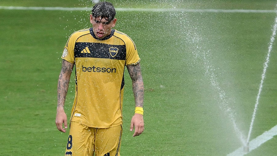 <div class="paragraphs"><p>Boca Juniors' Carlos Palacios as sprinklers are used to cool down the players during a break in play </p></div>