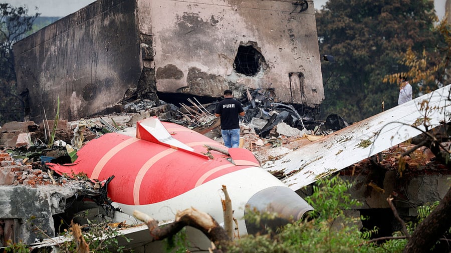 <div class="paragraphs"><p>A fire officer stands next to the crashed Air India Boeing 787-8 Dreamliner aircraft, in Ahmedabad, a day after the tragedy.</p></div>