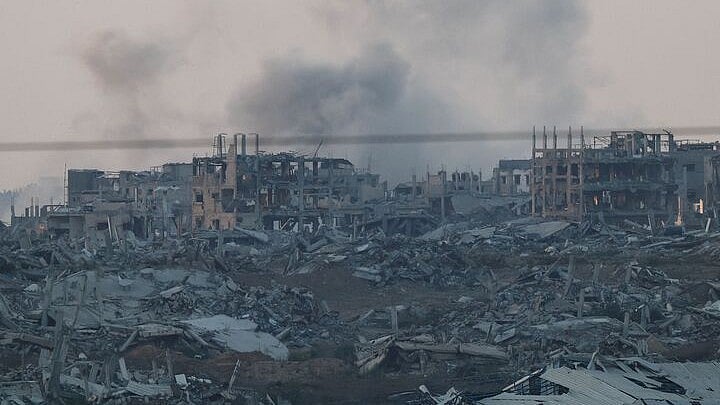 <div class="paragraphs"><p>Buildings lie in ruin inside the Gaza strip, as seen from Israel, </p></div>