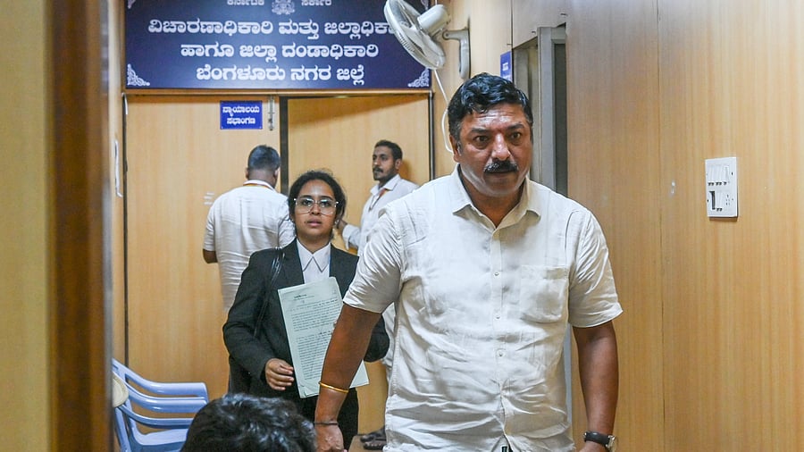 Satish, Security Manager at DNA, emerges from the deputy commissioner’s chamber after submitting his grievance, in Bengaluru on Friday.