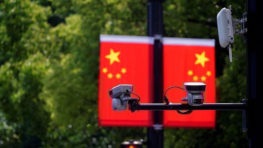 <div class="paragraphs"><p> Hikvision surveillance cameras are seen in front of a Chinese flag.</p></div>