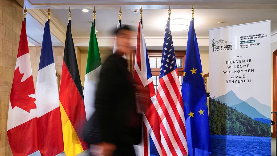 <div class="paragraphs"><p>A man walk past the G7 members flags at the Manoir Richelieu before the G7 Foreign Ministers summit in La Malbaie, Quebec, Canada.</p></div>