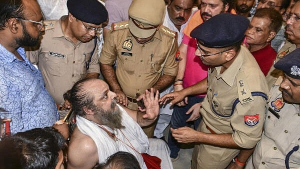<div class="paragraphs"><p>Police personnel interact with a Mahant and others during their dharna over tussle with cops allegedly over use of loudspeaker amid the ‘Rath Yatra’, in Kanpur.</p></div>