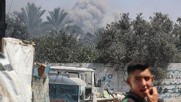 <div class="paragraphs"><p>Smoke rises following an Israeli air strike in Gaza City</p></div>