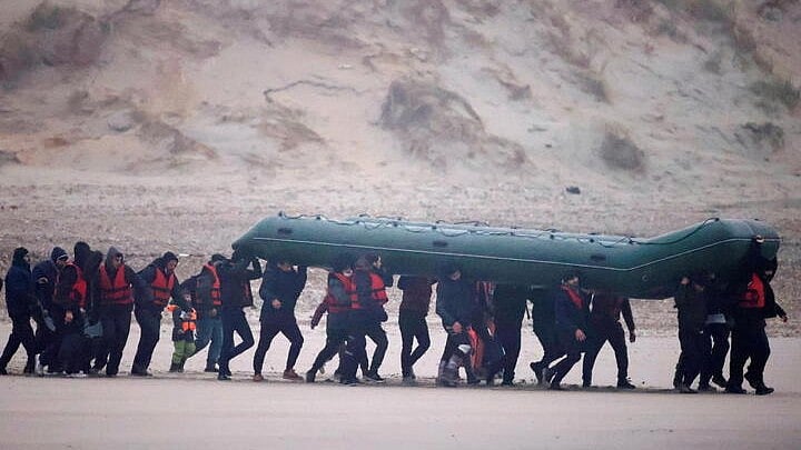 <div class="paragraphs"><p>Migrant dinghy heads off the French coast to cross the English channel.</p></div>
