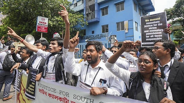 <div class="paragraphs"><p>Junior lawyers and law students stage a protest against the alleged rape of a student at a law college, in Kolkata</p></div>
