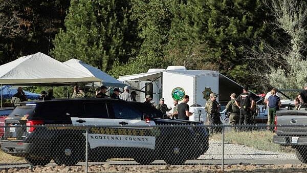 <div class="paragraphs"><p>Law enforcement officers gather at Cherry Hill Park after multiple firefighters were attacked when responding to a fire in the Canfield Mountain area outside Coeur d’Alene, Idaho</p></div>