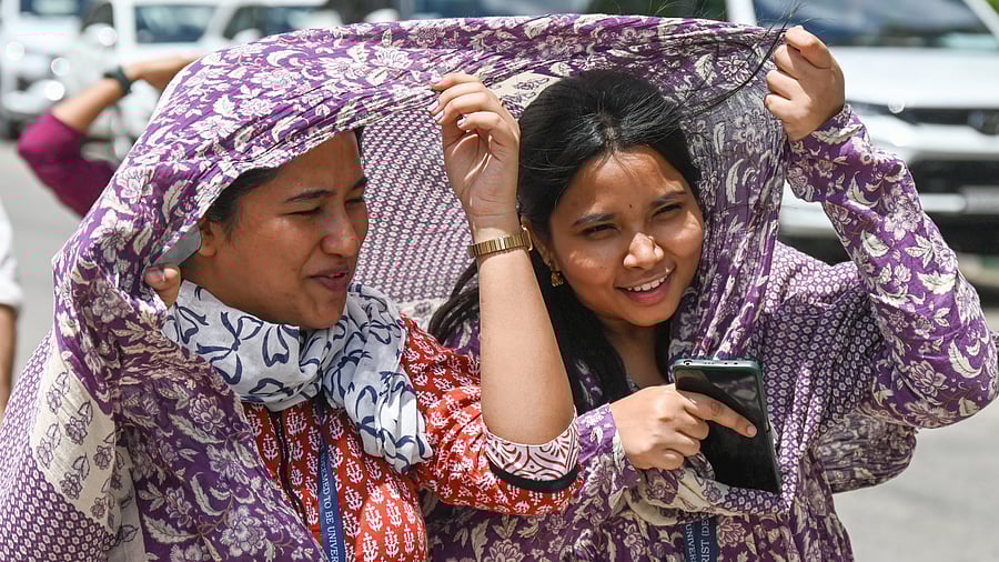 <div class="paragraphs"><p>Girls use head scarves to beat the sweltering heat. </p></div>