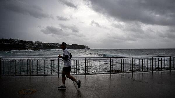 <div class="paragraphs"><p>A man runs as storm clouds hover above at Bronte Beach in Sydney, Australia.</p></div>