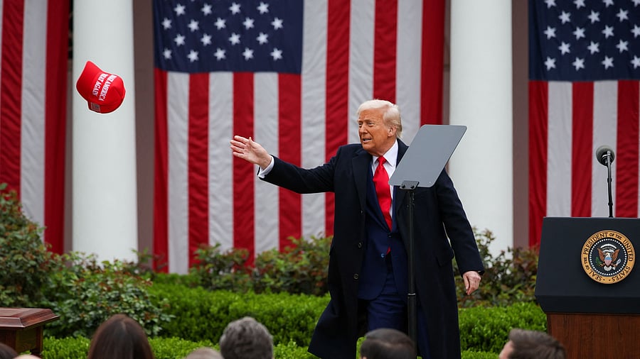 <div class="paragraphs"><p>US President Donald Trump tries to reach a MAGA hat</p></div>
