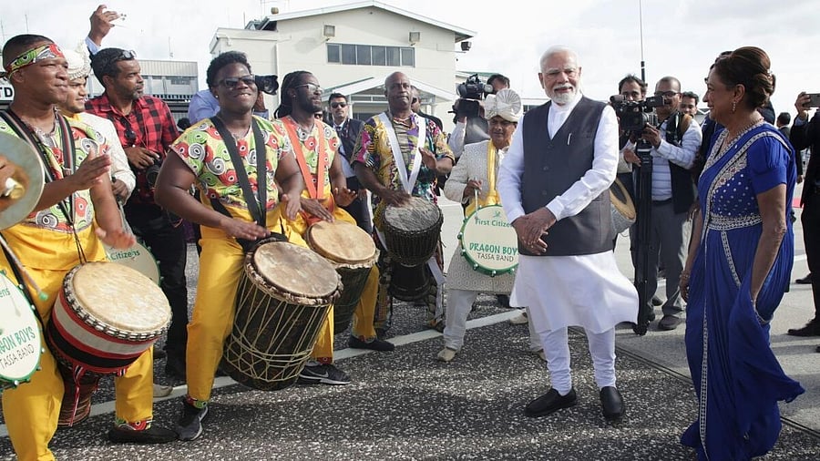 <div class="paragraphs"><p>Prime Minister Narendra Modi and Trinidad and Tobago Prime Minister Kamla Persad-Bissessar, dressed in traditional Indian attire, participate in a welcoming ceremony at Piarco International Airport in Piarco, Trinidad and Tobago, July 3, 2025.</p></div>