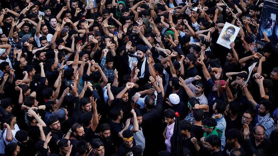 <div class="paragraphs"><p>Shi'ite mourners raise their hands and shout slogans during a Muharram procession ahead of Ashura in Srinagar.</p></div>