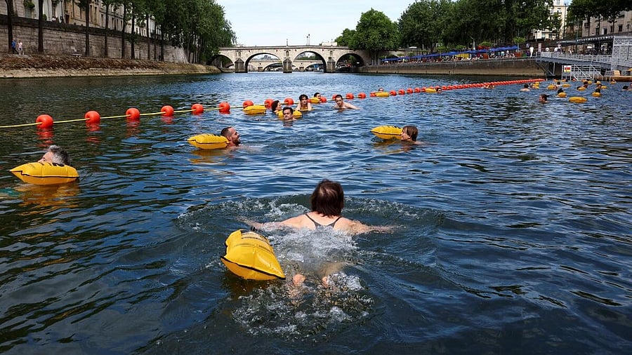 <div class="paragraphs"><p>People swim in the River Seine at the Bras Marie site, opened to swimmers marking the first public bathing session in the capital's historic waterway, in Paris, France, July 5, 2025.</p></div>