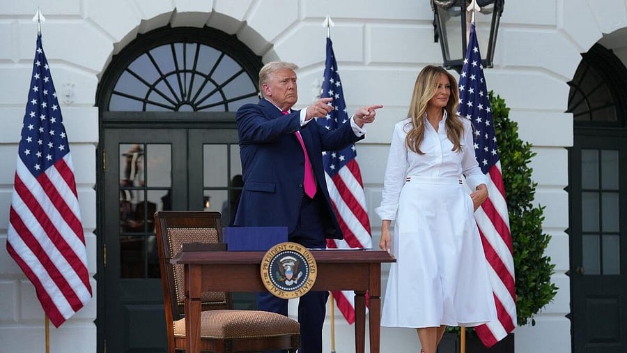 <div class="paragraphs"><p>US President Donald Trump gestures next to first lady Melania Trump.</p></div>