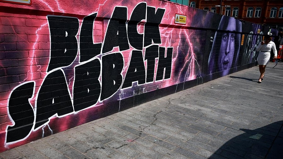 <div class="paragraphs"><p>A woman walks past a mural painted in honour of rock band Black Sabbath ahead of their upcoming concert in Birmingham.</p></div>