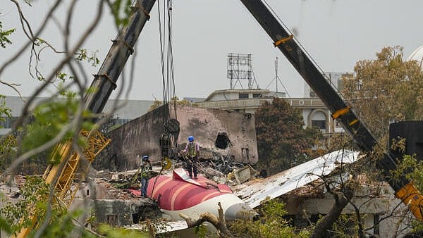 <div class="paragraphs"><p>Wreckage of the crashed Air India plane being lifted through a crane, in Ahmedabad, Gujarat.</p></div>