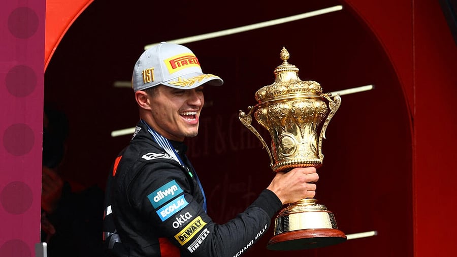 <div class="paragraphs"><p>McLaren's Lando Norris celebrates with a trophy on the podium after winning the British Grand Prix</p></div>