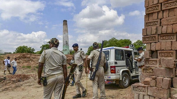<div class="paragraphs"><p>Police personnel stand guard at the site after a key suspect in the murder of industrialist Gopal Khemka was killed in a gunfight with the police</p></div>