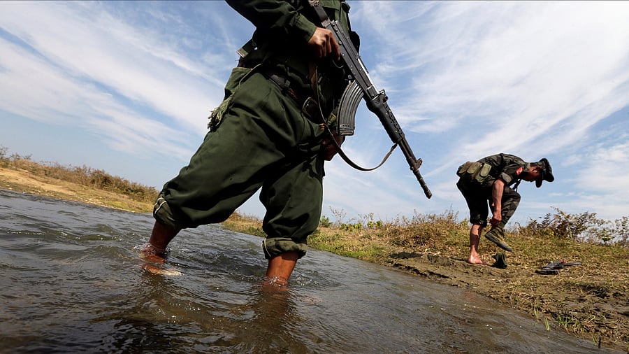 <div class="paragraphs"><p>A soldier from the Kachin Independence Army puts on his shoes as he and his comrade cross a stream towards the front line in Laiza.</p></div>