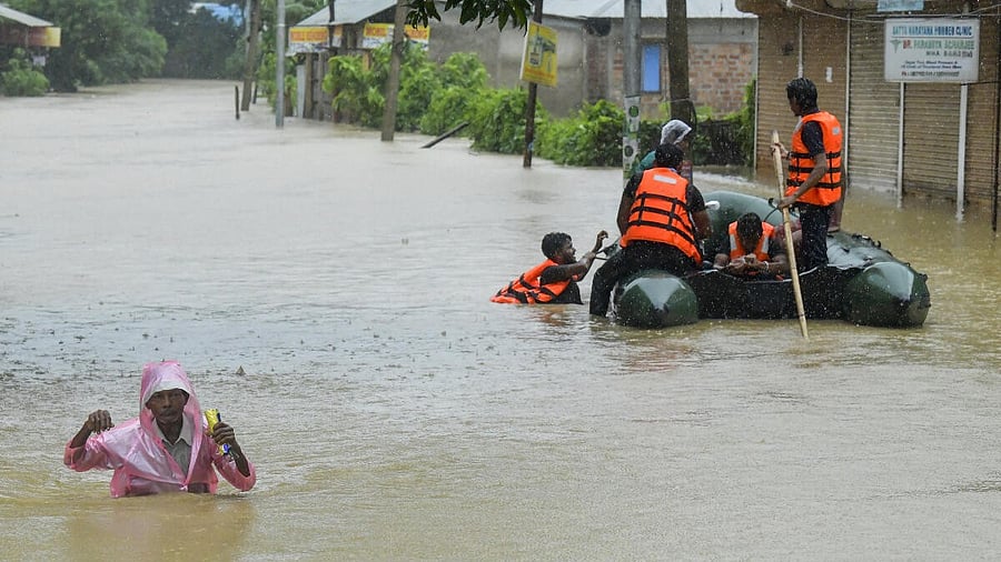 <div class="paragraphs"><p> A man wades through a flood-affected area amid rainfall, on the outskirts of Agartala, Tripura.</p></div>