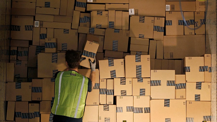 <div class="paragraphs"><p> A worker stacks a shipping trailer with boxed items for delivery at Amazon's distribution center.</p></div>